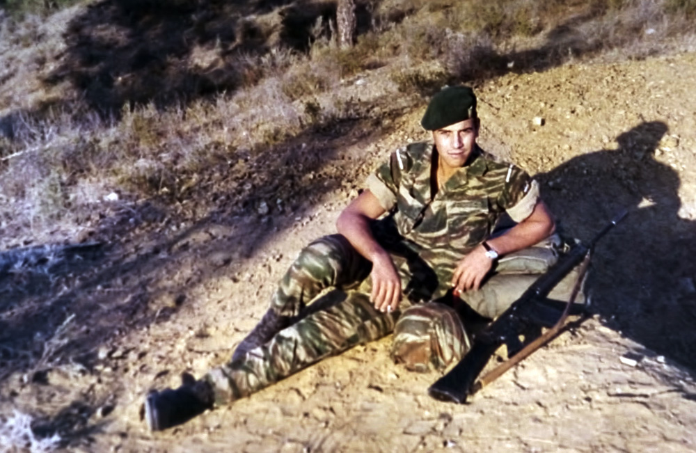 Απεικονίζεται ο Μανώλης Μπικάκης με στρατιωτική στολή καθισμένος πάνω σε ένα βουνό