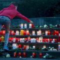 a-student-places-a-lit-candle-outside-the-josef-koenig-gymnasium-high-school.jpg