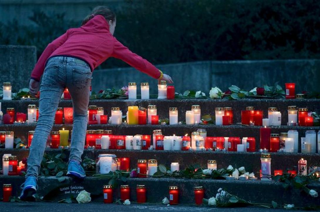 a-student-places-a-lit-candle-outside-the-josef-koenig-gymnasium-high-school.jpg