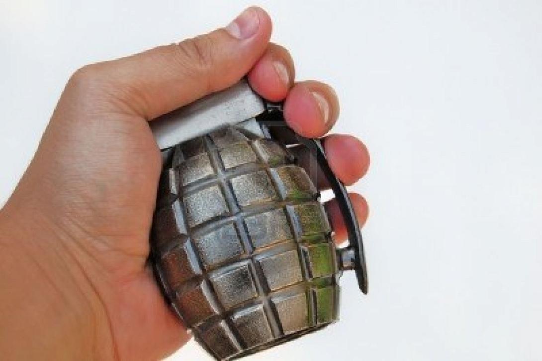 hand-holding-a-grenade-on-white-background.jpg